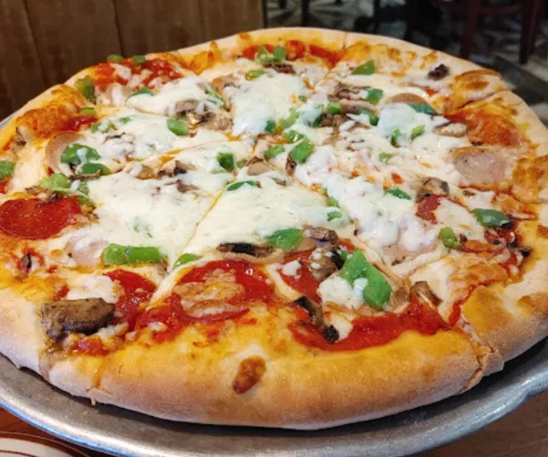 Fresh pizza with mushrooms peppers and cheese