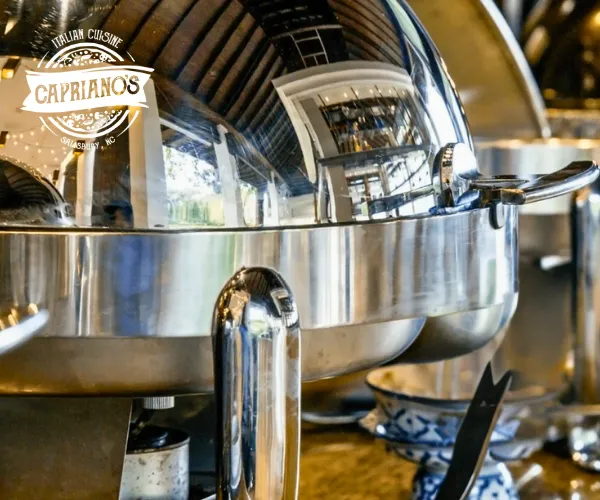Italian catering buffet setup with stainless chafing dishes