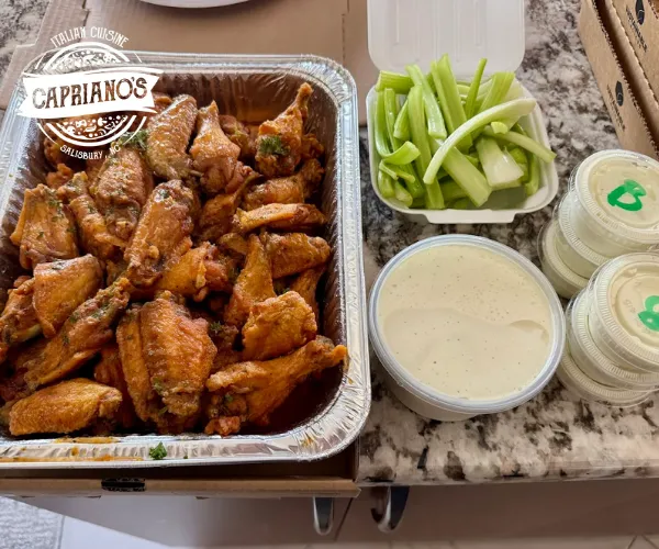 Italian catering wings with celery and dipping sauces