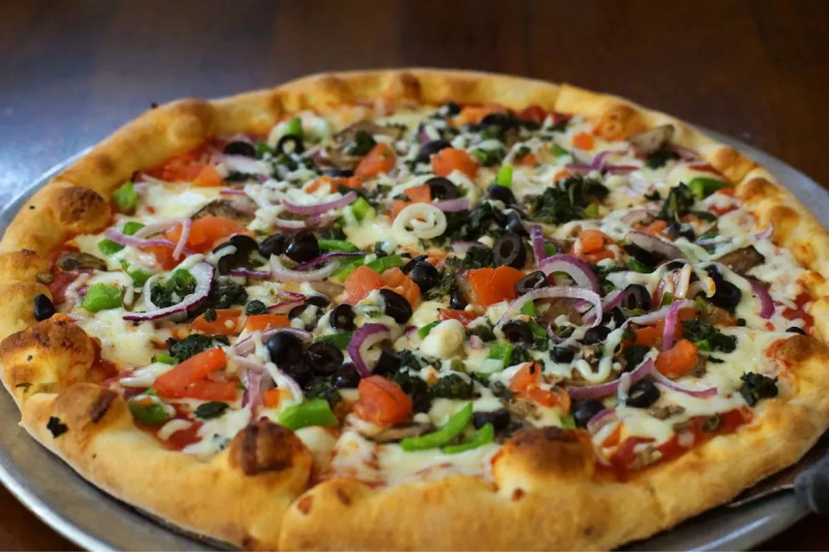 Loaded vegetable pizza with fresh toppings and golden crust